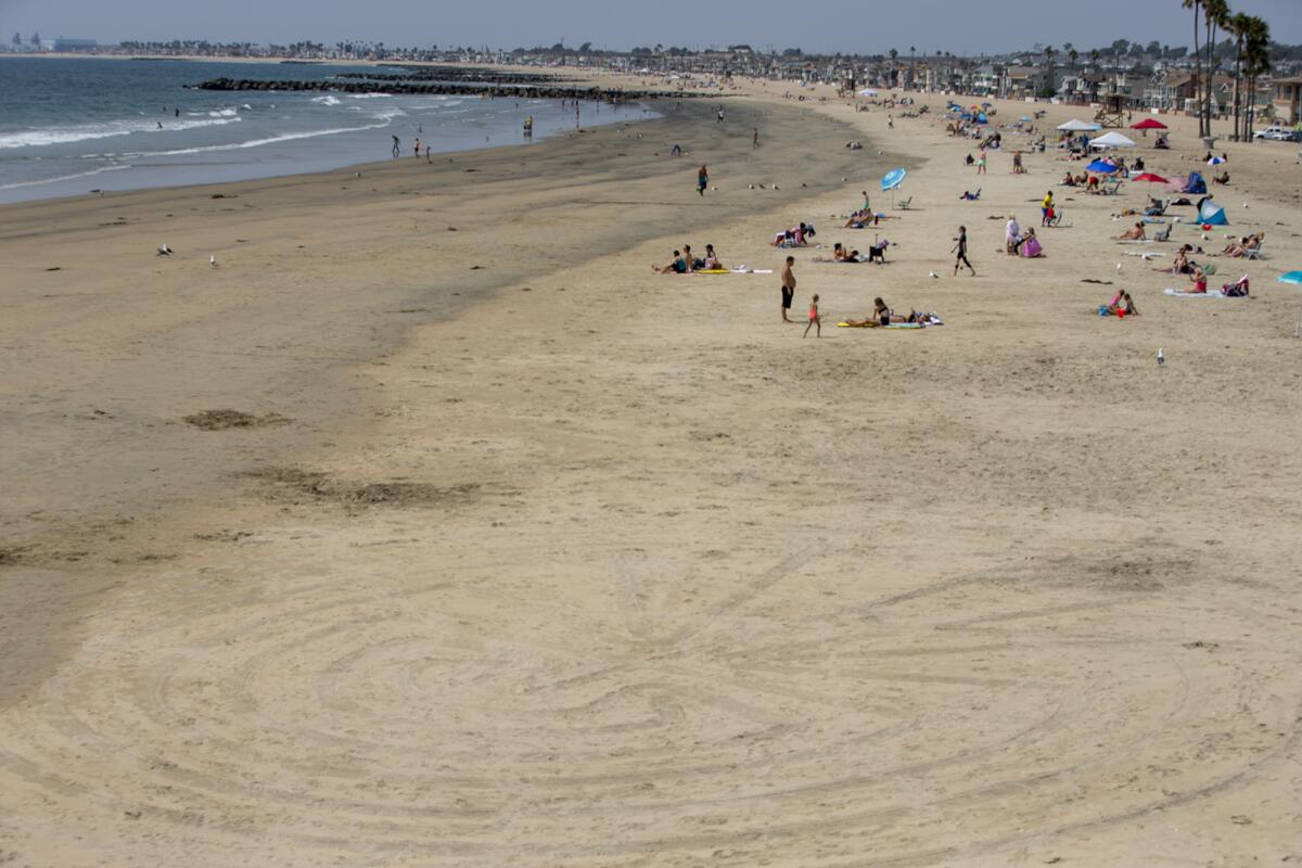 A large maze is carved into the sand near the Newport Beach Pier on Aug. 23.