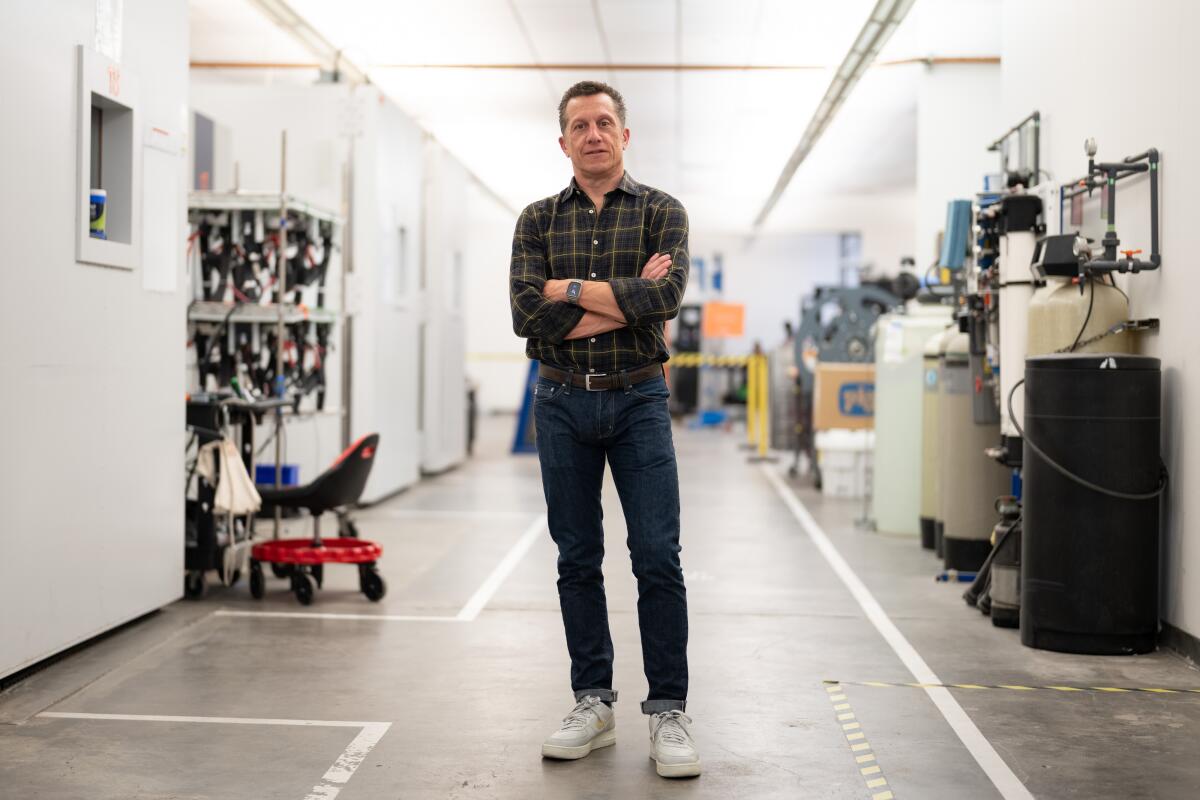 Pasquale Romano, until November president and chief executive of ChargePoint, stands in a test lab with arms crossed.