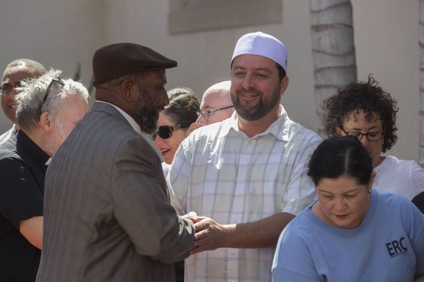Imam Taha Hassane, right, of the Islamic Center of San Diego, greeted Bishop Cornelius Bowser, left, of the Charity Apostolic Church.