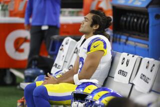 Rams wide receiver Puka Nacua sits on the sidelines in a game against Dallas.