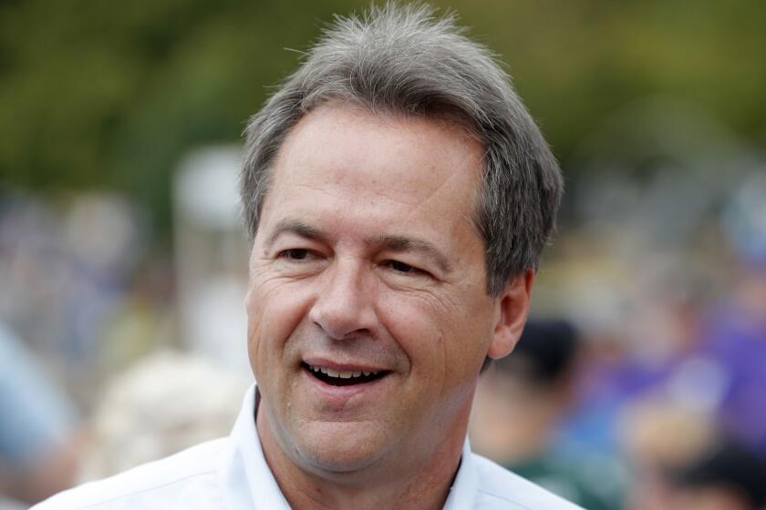 FILE - In this Aug. 16, 2018, file photo, Montana Gov. Steve Bullock walks down the main concourse during a visit to the Iowa State Fair in Des Moines, Iowa. Former Vice President Joe Biden and several nationally known senators are commanding most of the attention in Democrats early presidential angling, but there are several governors and mayors, including Bullock, eyeing 2020 campaigns, as well. (AP Photo/Charlie Neibergall, File)