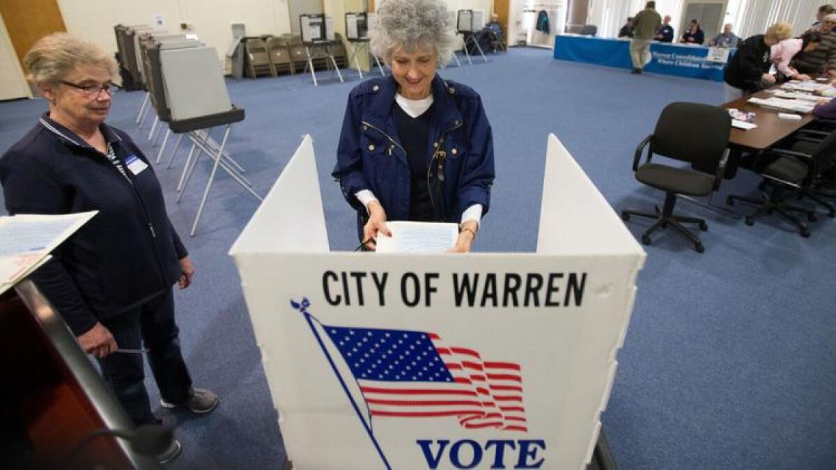 People vote in Warren, Mich., in the state's presidential primary.