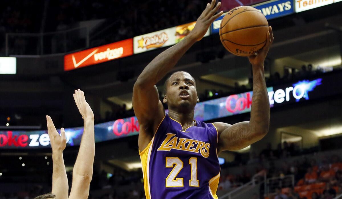 Lakers power forward Ed Davis elevates past Suns point guard Goran Dragic for a layup in the first half of their game Wednesday night in Phoenix.