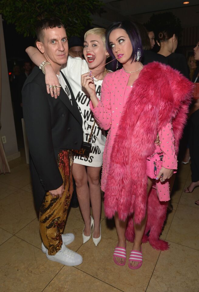 Designer Jeremy Scott, left, Miley Cyrus and Katy Perry pal around at the Daily Front Row Fashion Los Angeles Awards Show at Sunset Tower on Thursday.