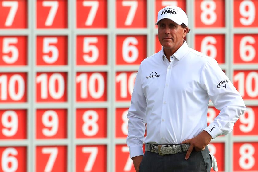 Phil Mickelson waits on the 18th green during the WGC HSBC Champions on Nov. 1 in Shanghai.