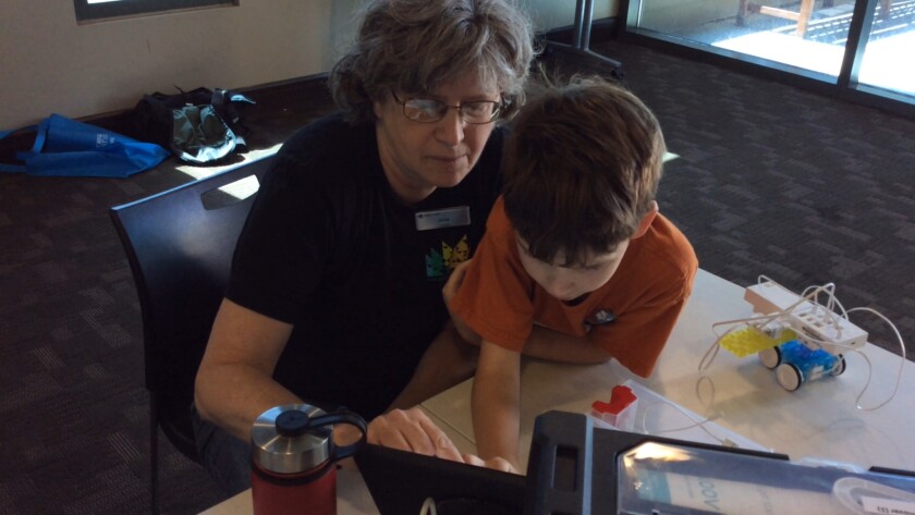 Librarian Janet Gastil instructs Nate Hull during Robotics for Kids program at the Bonita-Sunnyside Branch Library.