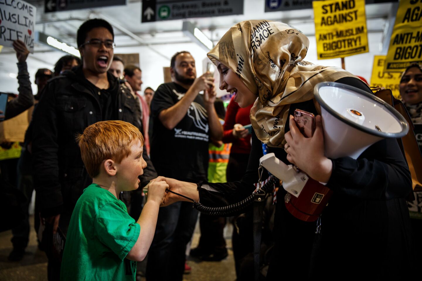 Cooper Chvotkin, 6, gets a turn to voice his opinion on the megaphone with other protesters at LAX on Saturday.