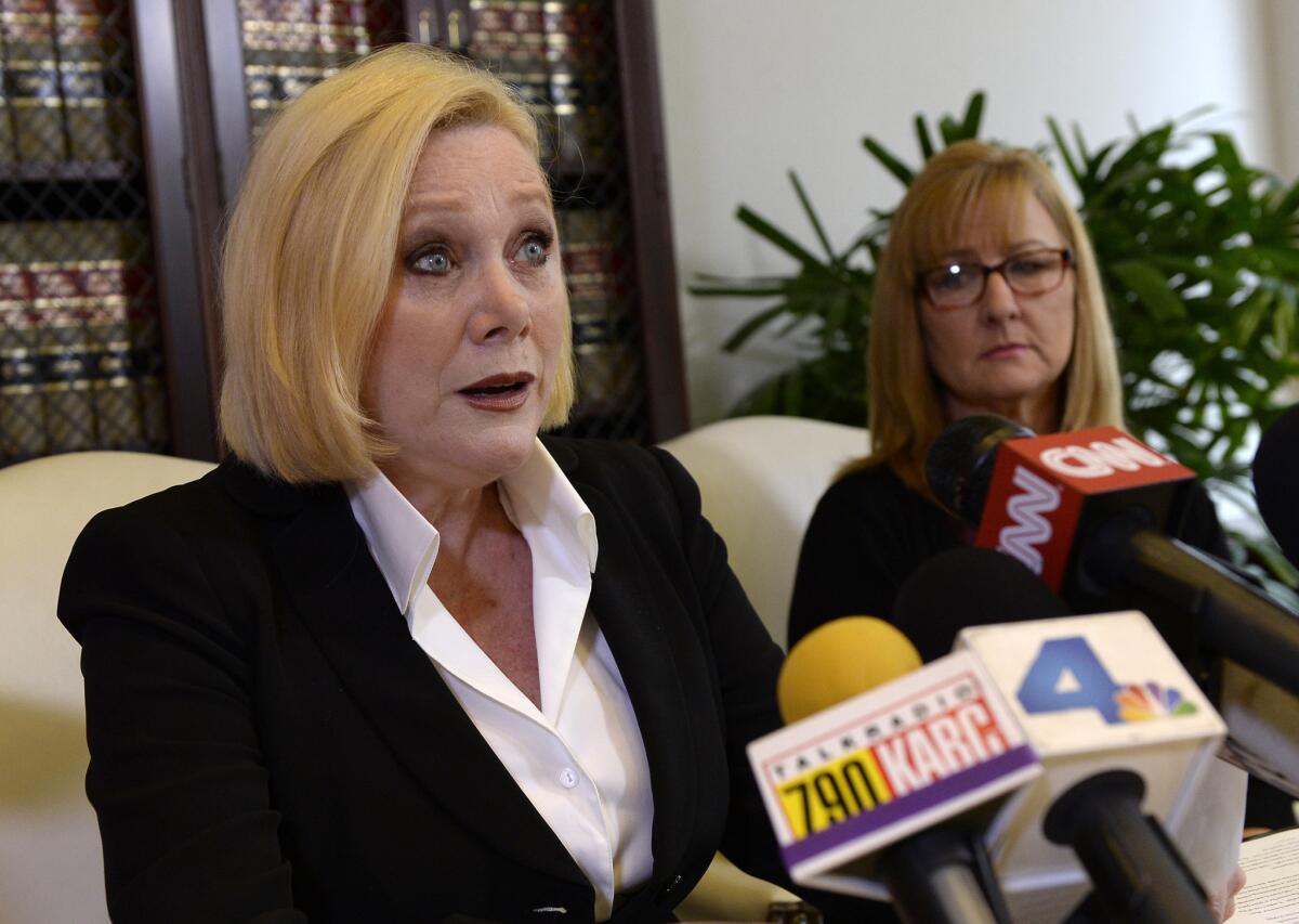 Marcella Tate, left, speaks during an April 2015 news conference with attorney Gloria Allred in Los Angeles.