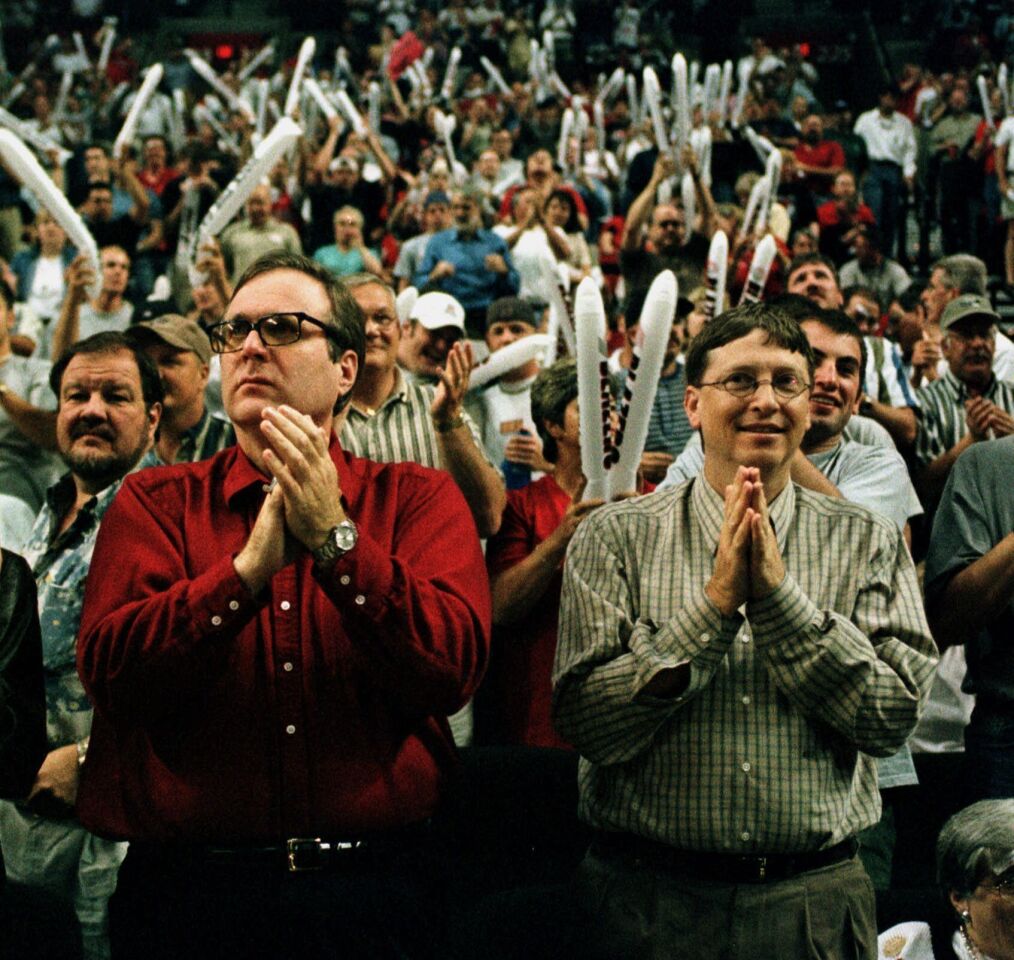 Portland Trail Blazers owner Paul Allen, left, is joined by Bill Gates as they cheer on the Blazers against the Utah Jazz during NBA playoff action in Portland, Ore. on May 27, 1999. Allen, billionaire owner of the Portland Trail Blazers and the Seattle Seahawks and Microsoft co-founder, died Monday, Oct. 15, 2018 at age 65.