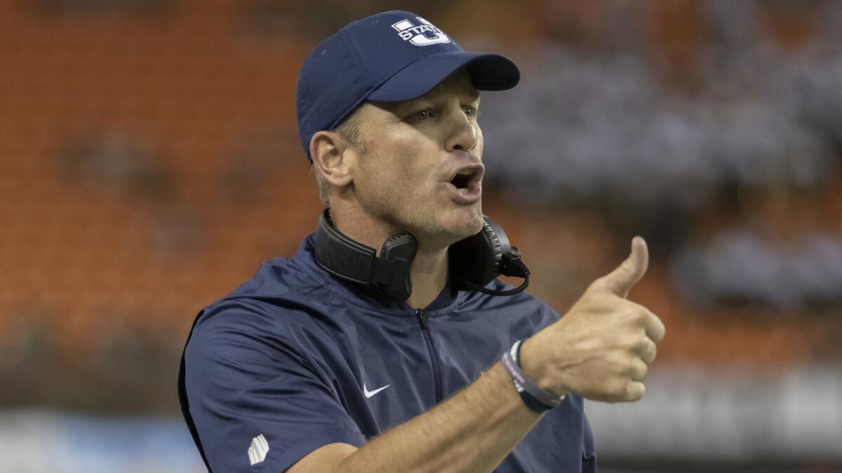 Matt Wells gestures to officials during the first half against Hawaii in Honolulu. Texas Tech has hired Wells as its new football coach after he was part of an impressive turnaround at Utah State, his alma mater.