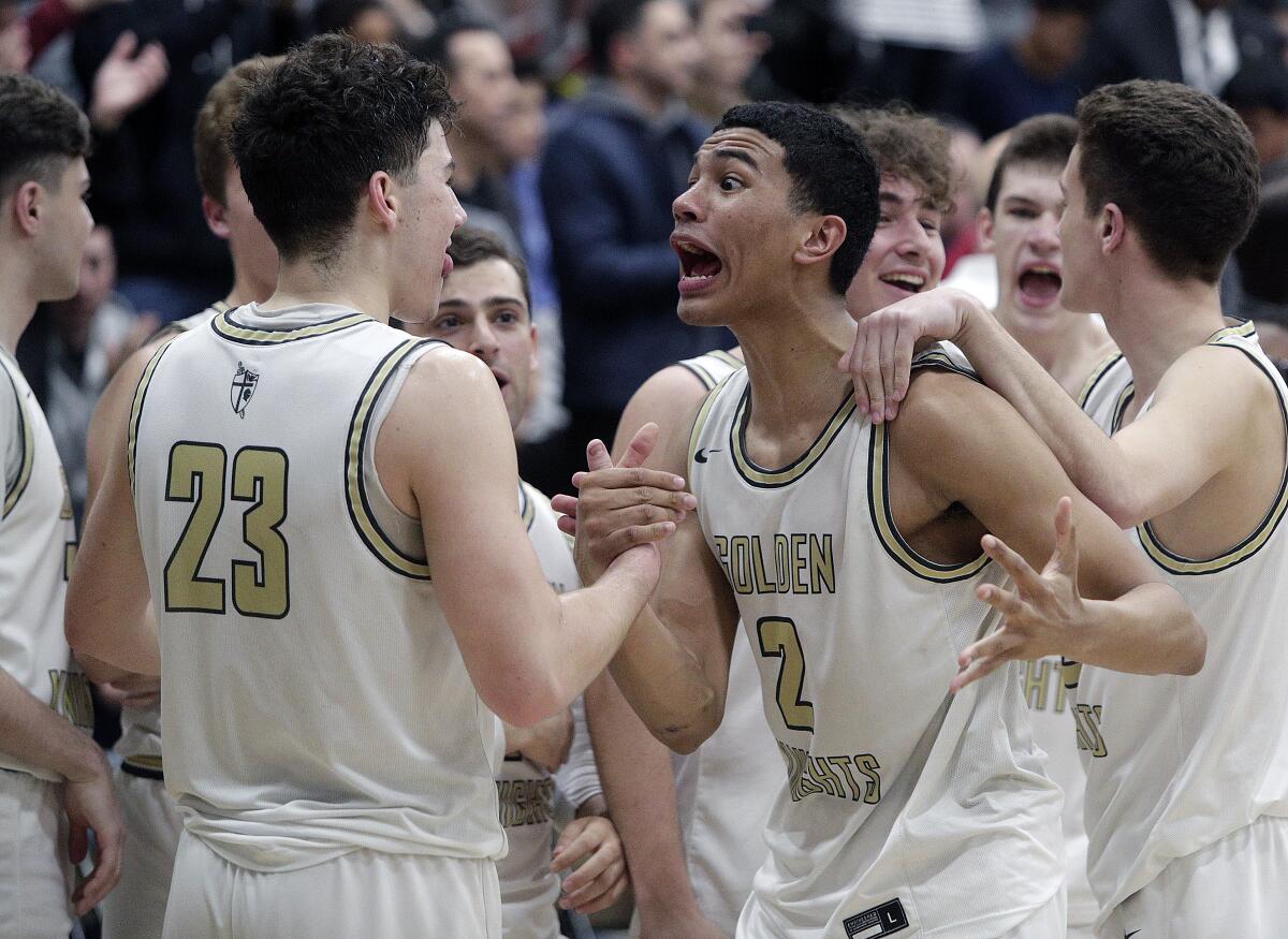 St. Francis' Andre Henry (2) greets teammates after a victory over Eastvale Roosevelt in the Southern California Regional Division II final in what turned out to be his final high school game after the cancellation of the state basketball championships.