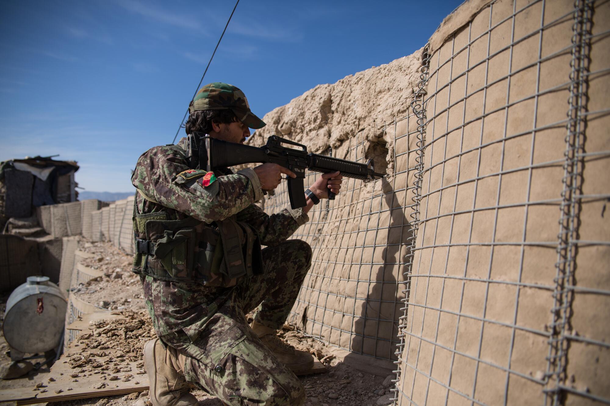 At the Zabul province outpost, an Afghan soldier keeps watch.