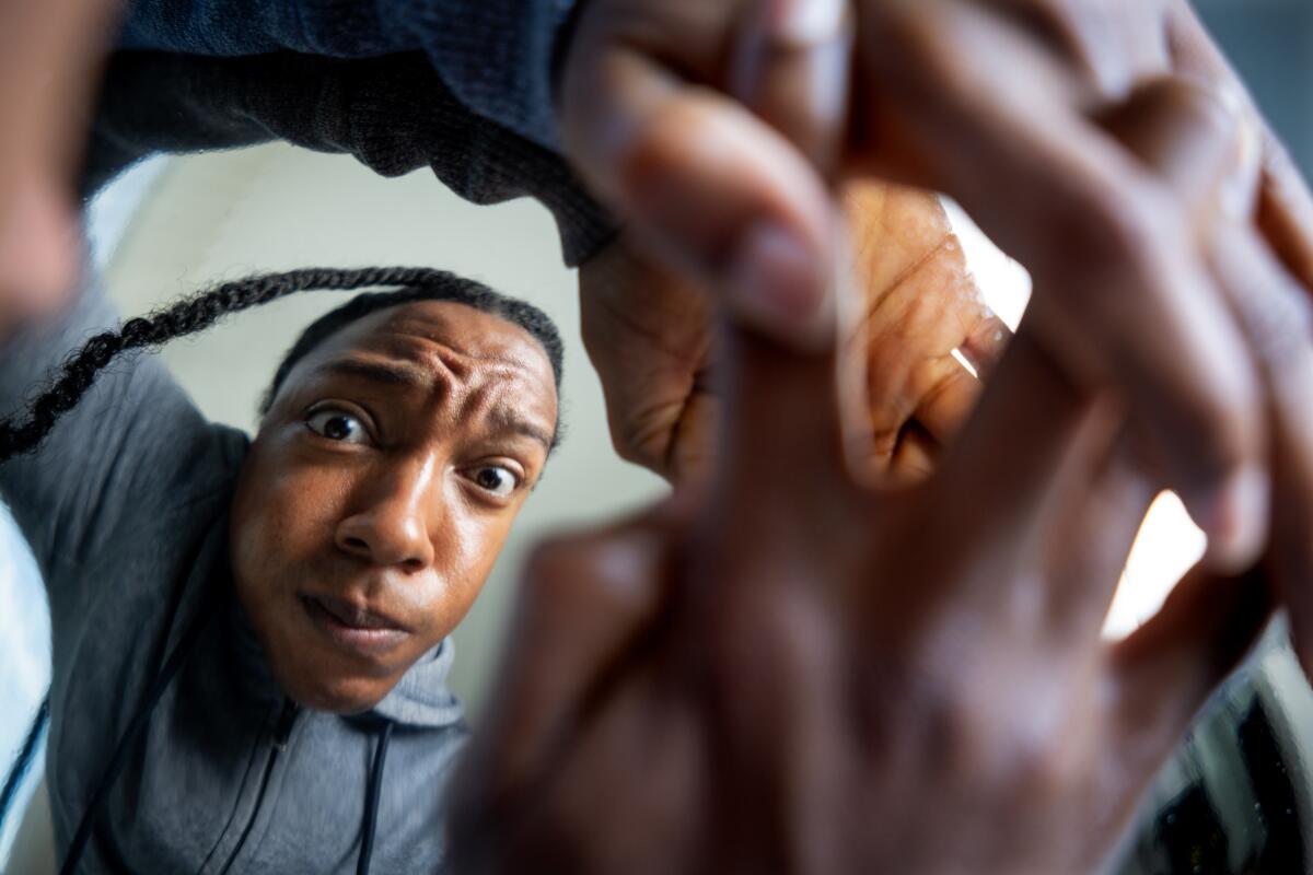  Comedian Josh Johnson photographed through his fingers.