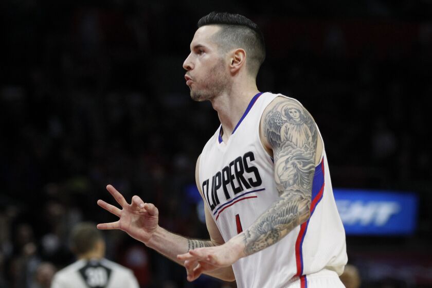 Clippers guard J.J. Redick gestures with his fingers after sinking a 3-point shot 
