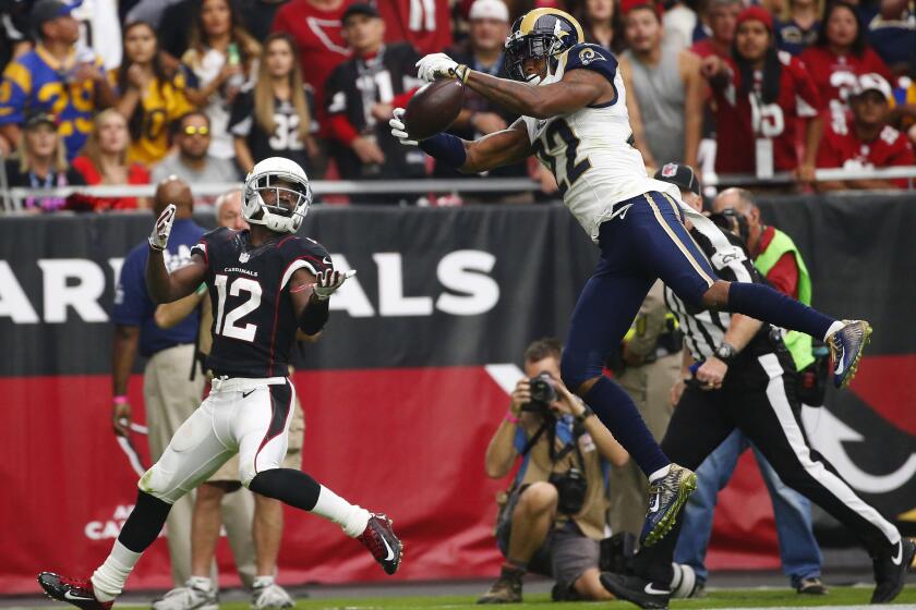 Rams cornerback Trumaine Johnson, right, intercepts a pass intended for Arizona Cardinals wide receiver John Brown during a game Oct. 2.