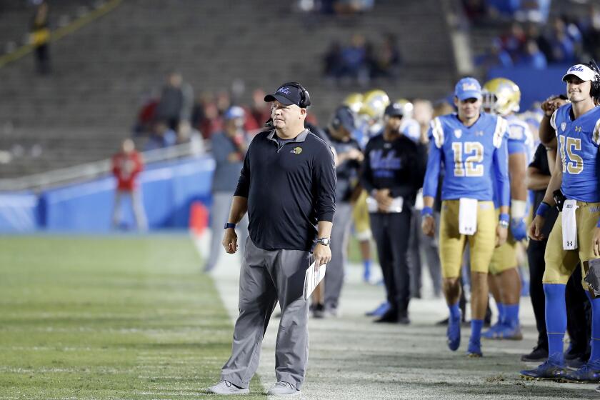 UCLA coach Chip Kelly watches the Bruins lose to Utah in a largely empty Rose Bowl on Oct. 26.