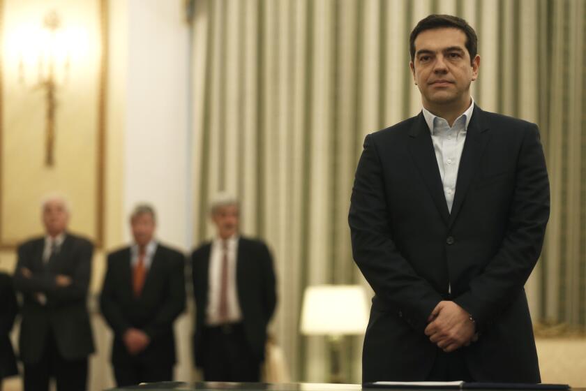 Greek Prime Minister Alexis Tsipras stands before taking a secular oath at the presidential palace in Athens on Jan. 26.