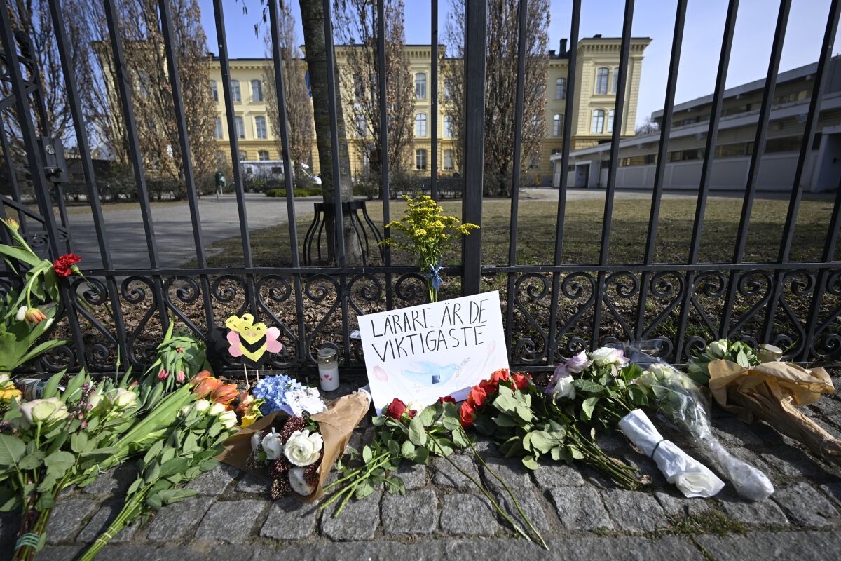 Floral tributes outside a school where two teachers were killed