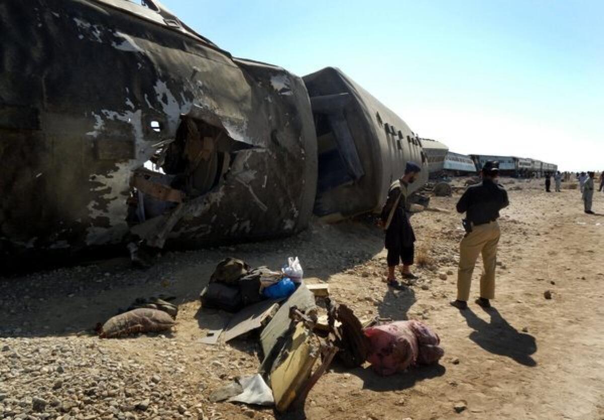 Pakistani security officials inspect a Jaffar Express train hit by a bomb blast near Nasirabad district in the Baluchistan province of Pakistan on Monday.