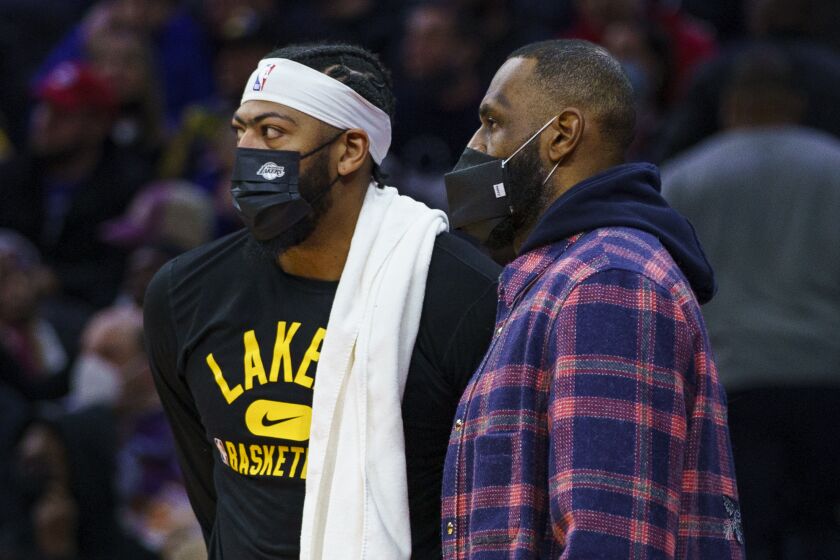 The Lakers' Anthony Davis, left, looks on with LeBron James during the second half Jan. 27, 2022, at Philadelphia.
