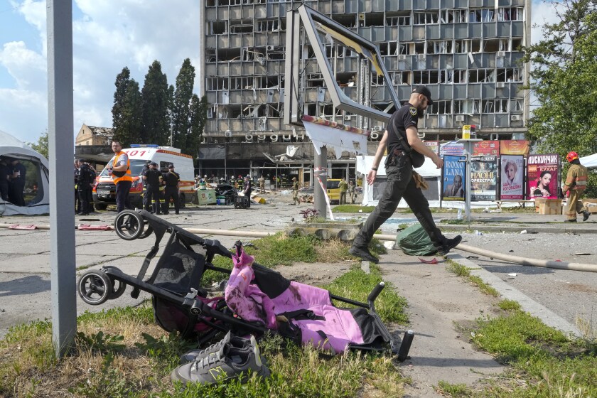 A baby stroller lies by a road after a deadly Russian missile attack in Vinnytsia, Ukraine, Thursday, July 14, 2022. (AP Photo/Efrem Lukatsky)