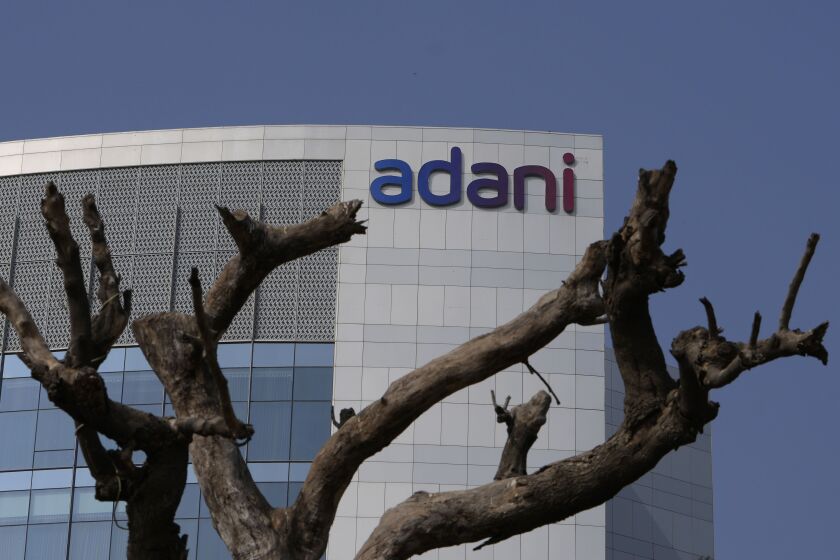 FILE- Dried branches of a tree stand outside Adani Corporate House in Ahmedabad, India, Friday, Jan. 27, 2023. India’s Adani Group, run by Asia’s richest man, has hit back at a report from U.S.-based short-seller Hindenburg Research, calling it “malicious”, “baseless” and full of “selective misinformation.” (AP Photo/Ajit Solanki, File)