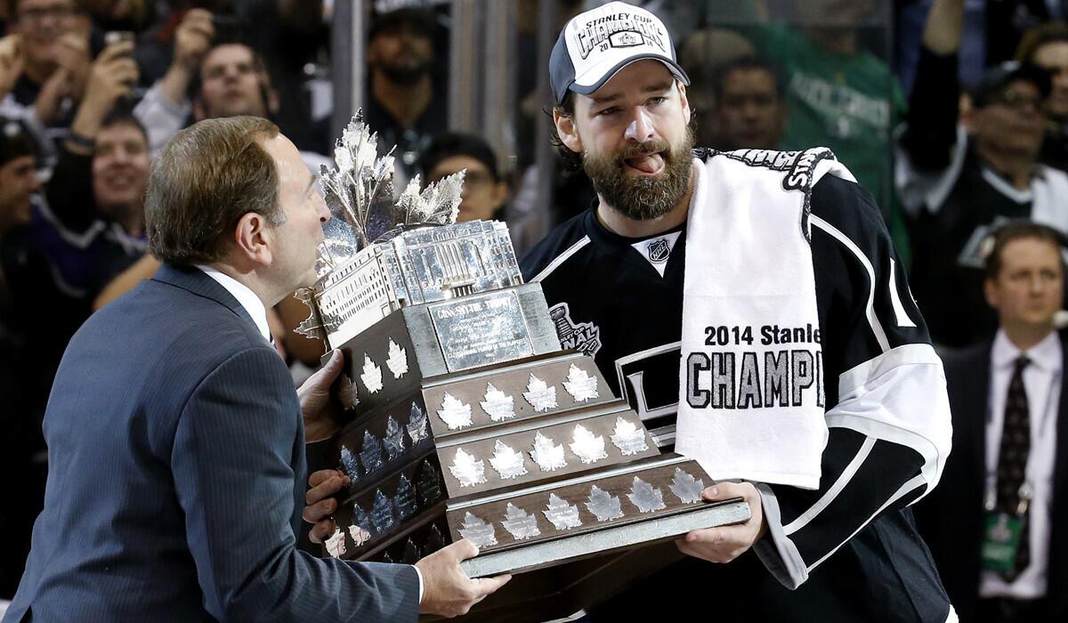 Justin Williams receives the Conn Smythe Trophy from NHL Commissioner Gary Bettman after the Kings defeated the New York Rangers in Game 5 of the Stanley Cup Final on Friday night at Staples Center.