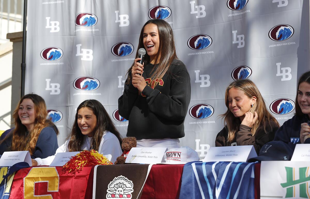 Water polo player Lauren Schneider, a USC commit, stands up to thank her parents during a national signing day ceremony.