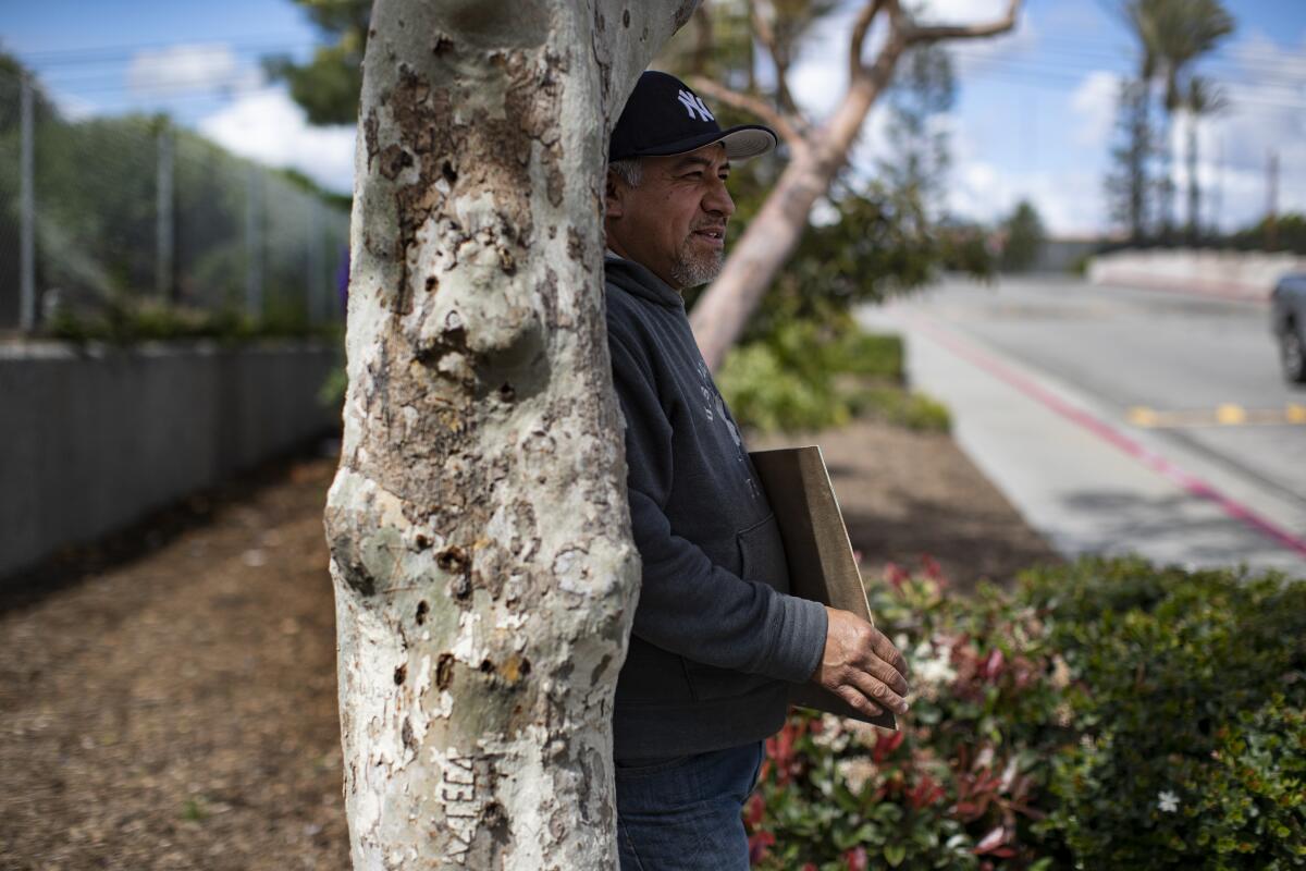 Gabriel Reyes, 49, of Bellflower was laid off  during the pandemic and is now trying to get work as a day laborer outside Paramount Home Depot.