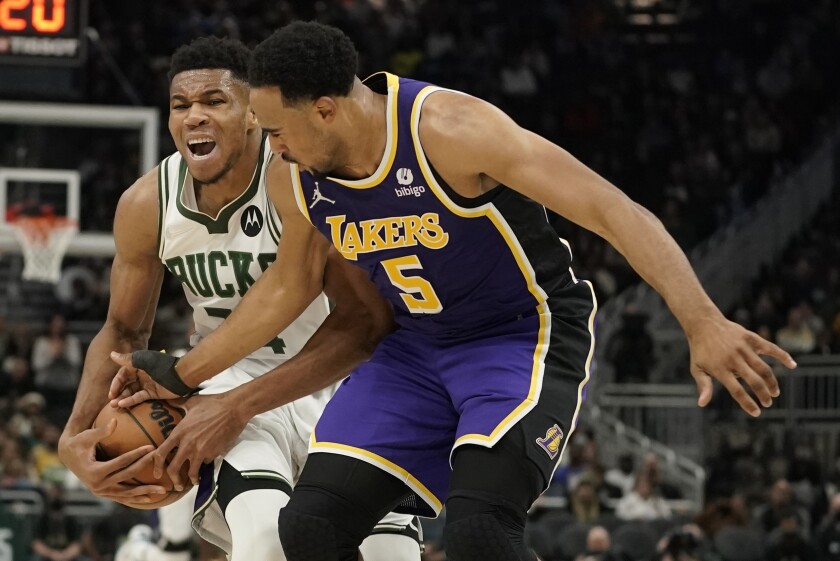 Milwaukee Bucks' Giannis Antetokounmpo tries to get past Lakers' Talen Horton-Tucker.