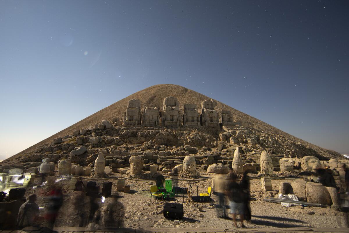 Stargazers gather to watch the Perseid meteor shower among ancient statues atop Mount Nemrut in southeastern Turkey, Saturday, Aug. 13, 2022. Hundreds spent the night at the UNESCO World Heritage Site for the annual meteor show that stretches along the orbit of the comet Swift–Tuttle. Perched at an altitude of 2,150 meters (over 7,000 feet), the statues are part of a temple and tomb complex that King Antiochus I, of the ancient Commagene kingdom, built as a monument to himself. (AP Photo/Emrah Gurel)