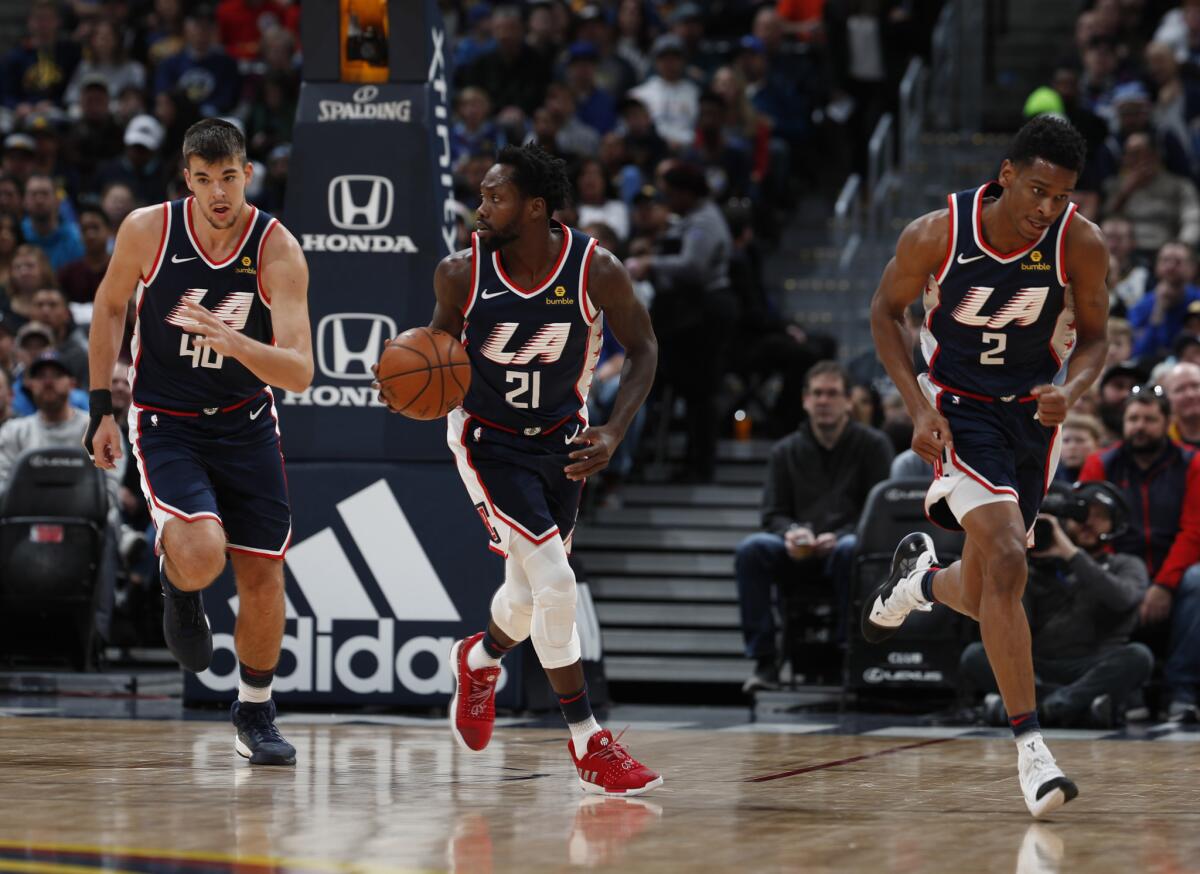 From left, Los Angeles Clippers center Ivica Zubac (40), Los Angeles Clippers guard Patrick Beverley (21) and Los Angeles Clippers guard Shai Gilgeous-Alexander (2) in the first half of an NBA basketball game Sunday, Feb. 24, 2019, in Denver.