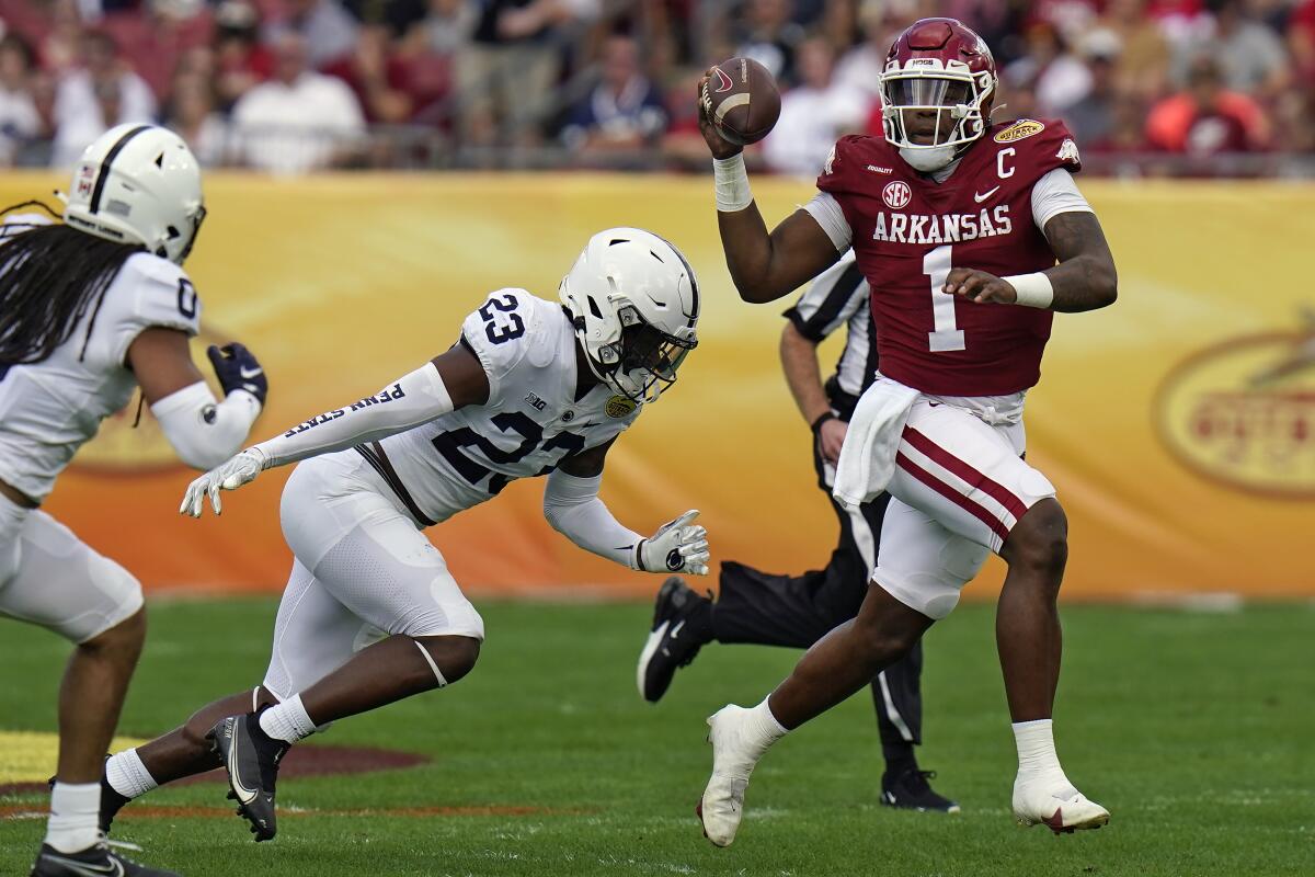 Arkansas quarterback KJ Jefferson eludes Penn State linebacker Curtis Jacobs.