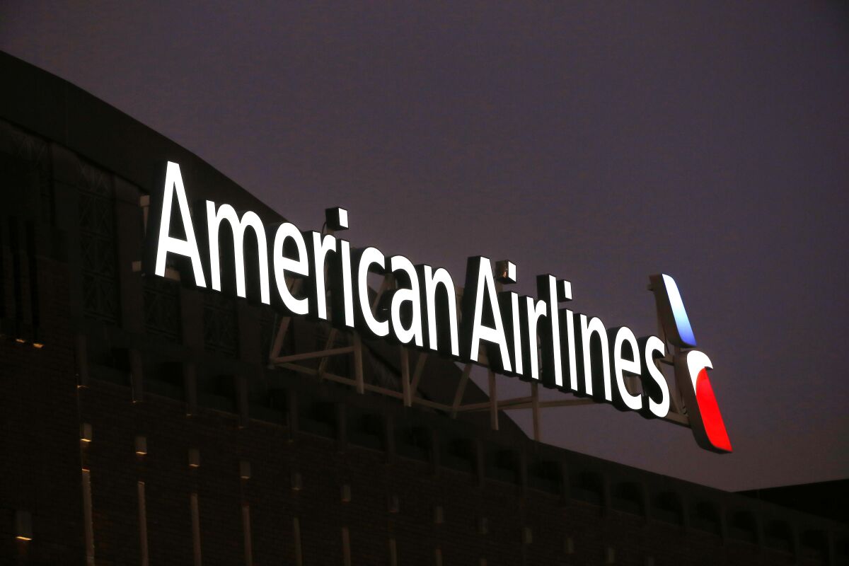 This Dec. 19, 2017, photo shows the American Airlines logo on top of the American Airlines Center in Dallas. The longest-running in-flight magazine on a major airline is nearing its final flight. American Airlines says it is dropping the American Way magazine, Friday, June 11, 2021, after a 55-year run. (AP Photo/ Michael Ainsworth, File)