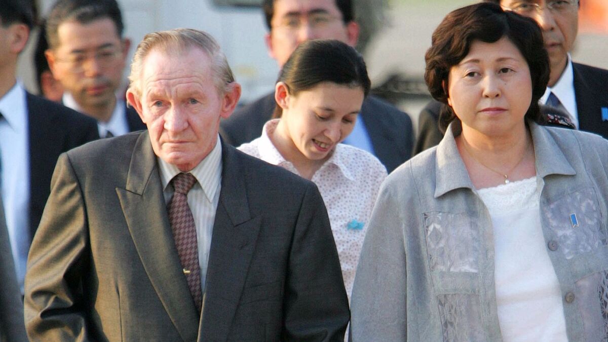 Former U.S. Army deserter to North Korea Charles Jenkins, left, escorted by his wife, Hitomi Soga, right, and their daughter Mika, center, arrives at Tokyo's Haneda International Airport in 2004.