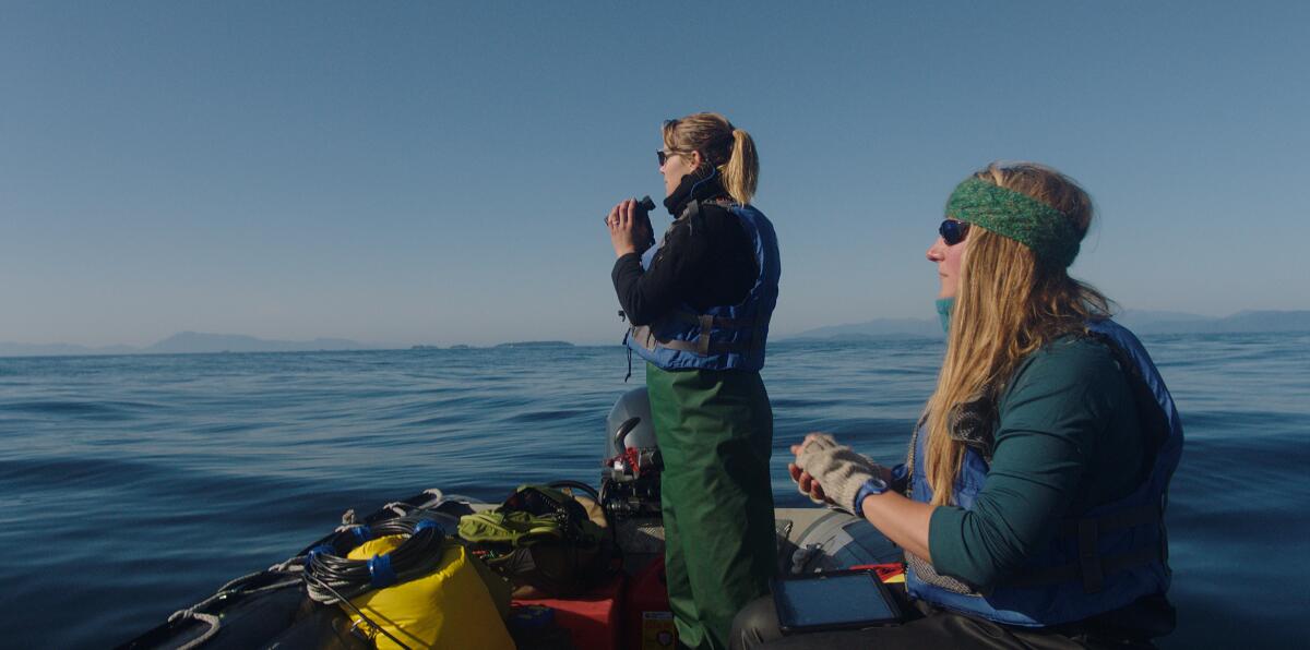 Two women at sea in a small boat.