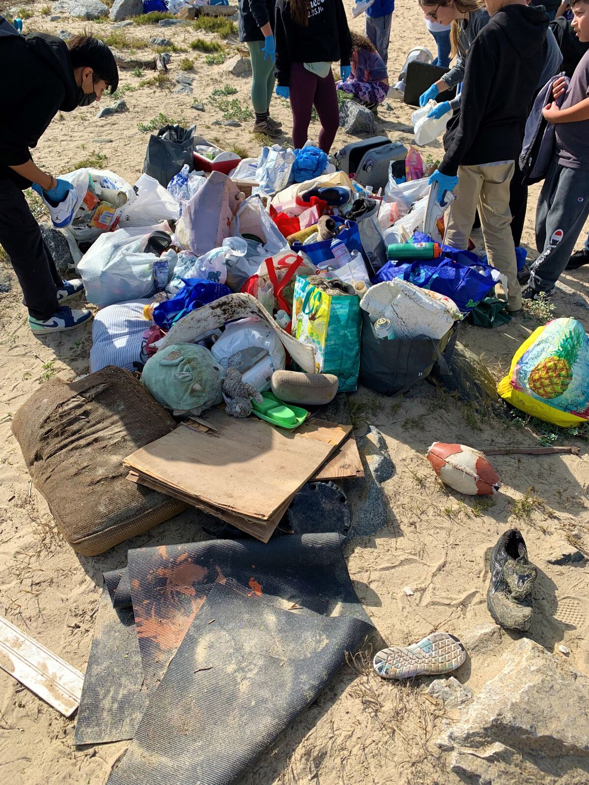 Inland Empire students collected 200 pounds of trash Thursday during a post-rain cleanup of Huntington State Beach.