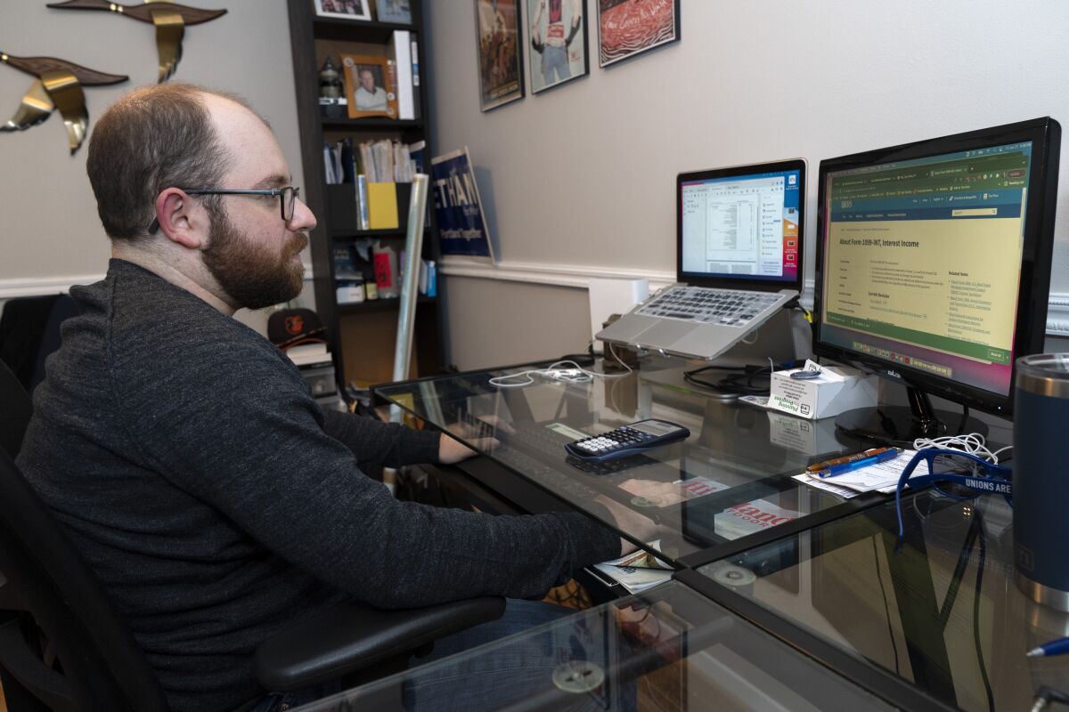 Ethan Miller works on his taxes at home on a computer