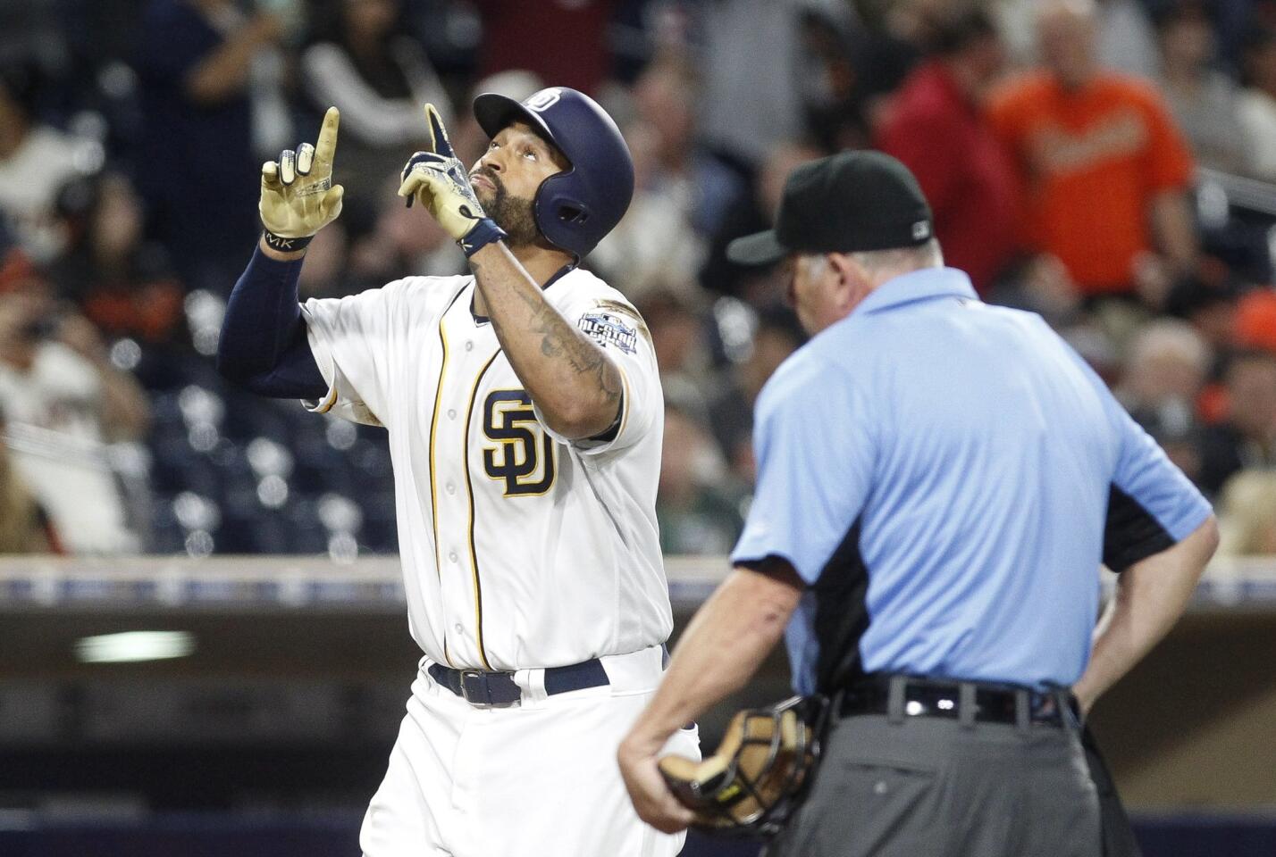 The Padres' Matt Kemp points up after hitting a home run in the ninth inning.