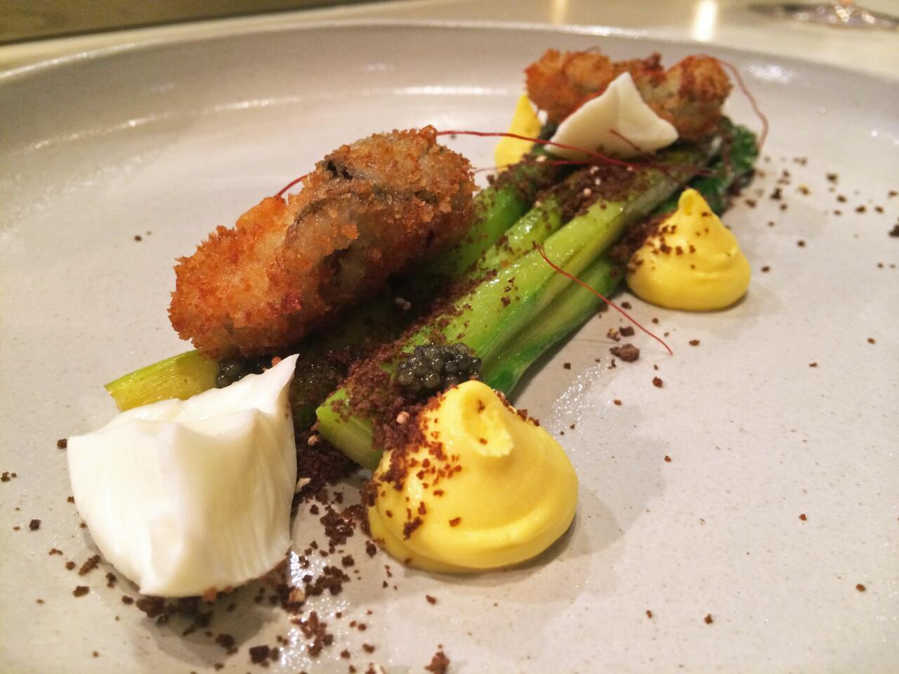 Asparagus with fried oysters, pickled egg whites, deviled egg puree, caviar, black bread crumbs and chile threads.
