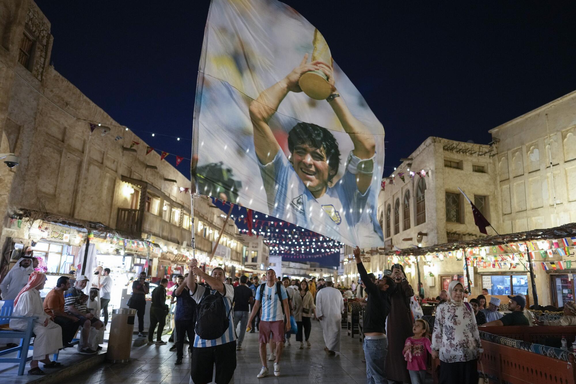 A fan of Argentina waves a flag with th 