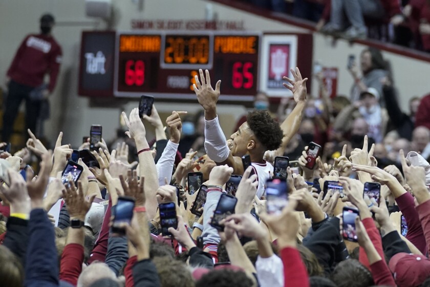 Indiana's Rob Phinisee, center right, celebrates with fans after the team defeated Purdue in an NCAA college basketball game, Thursday, Jan. 20, 2022, in Bloomington, Ind. (AP Photo/Darron Cummings)