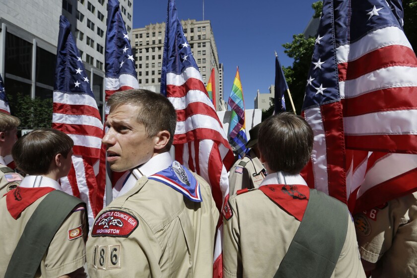 Boy Scouts from the Chief Seattle Council carry U.S. flags as they prepare to march in the Gay Pride Parade in downtown Seattle in June 2013.