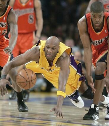 Lakers forward Lamar Odom heads to the floor ahead of Warriors guard Kelenna Azubuike for a loose ball during the fourth quarter Thursday night.