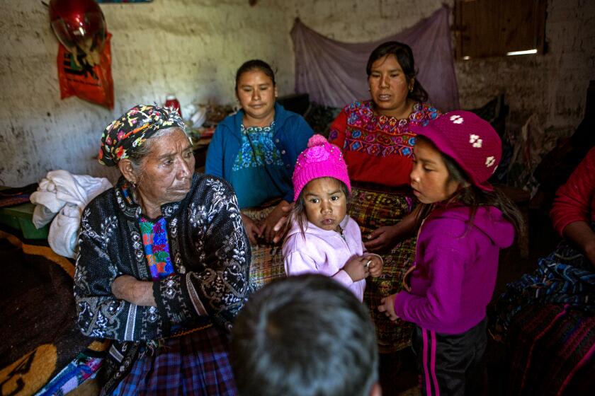 Family and neighbors gather in the home of migrant Rivaldo Jimenez, in Comitancillo, Guatemala, Wednesday, Jan. 27, 2021. Jimenez family members believe he may be one of the charred corpses found in a northern Mexico border state on Saturday. The country's Foreign Ministry said it was collecting DNA samples from a dozen relatives to see if there was a match with any of the bodies. (AP Photo/Oliver de Ros)