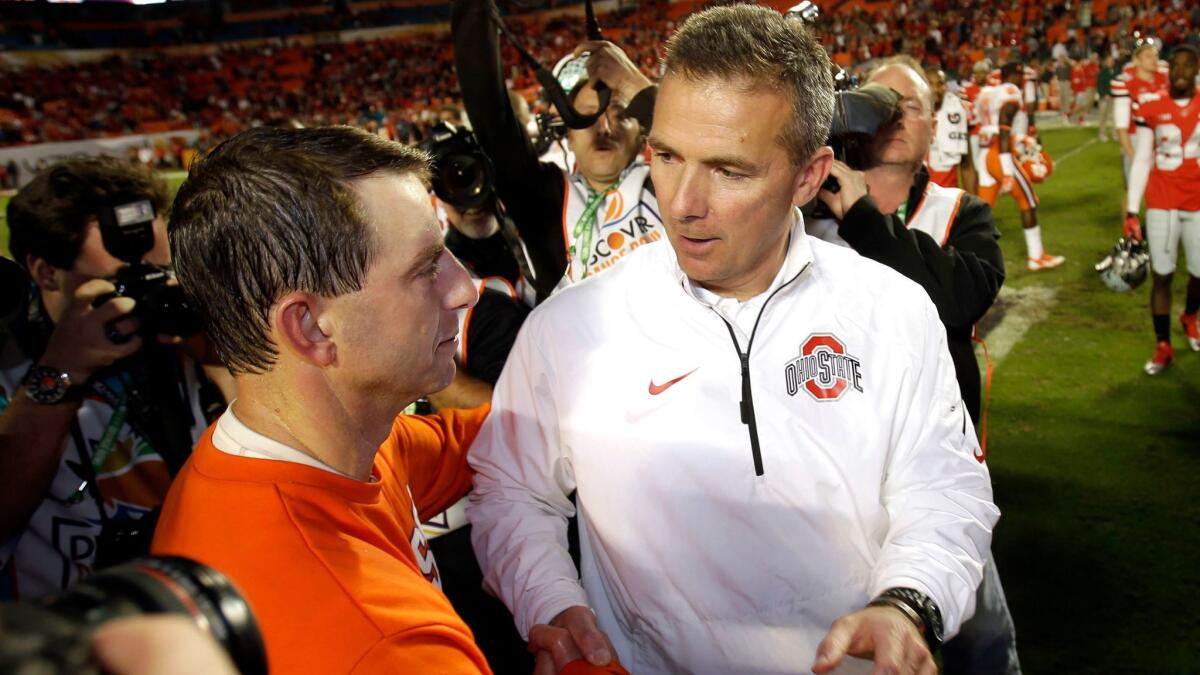 Ohio State Coach Urban Meyer, right, shakes hands with Clemson Coach Dabo Swinney after the 2014 Orange Bowl.