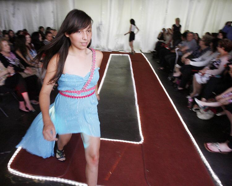 Yoselin Galdamez finishes her modeling of the dress she is wearing at the Debut Annual Rosemont Fashion Show at Rosemont Middle School in La Crescenta on Monday, June 13, 2011. Several 8th grade girls performed in the fashion show featuring several different outfits and designs they created.