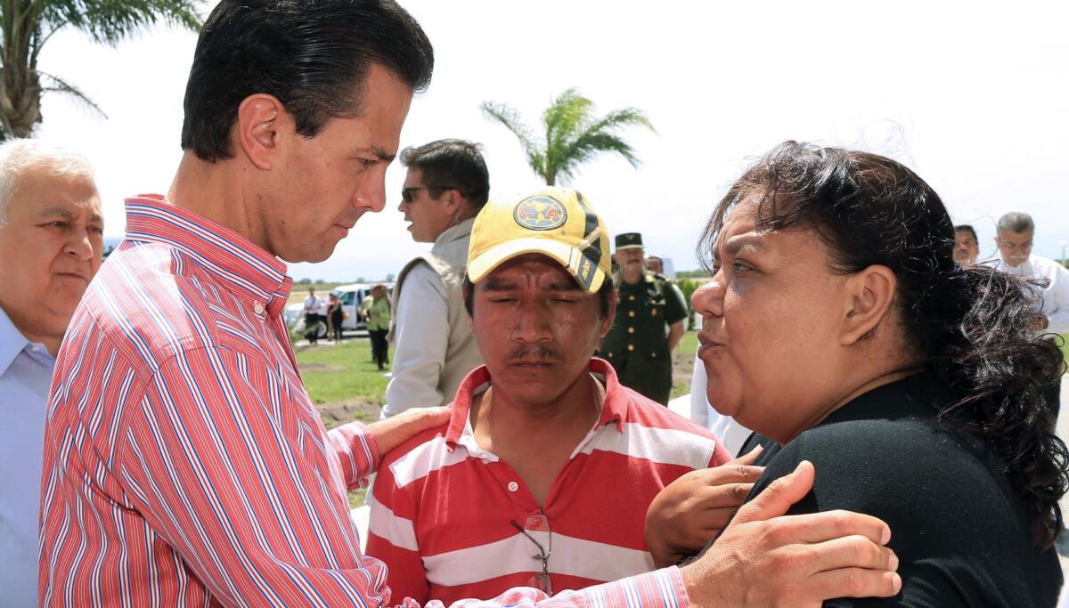 Mexican President Enrique Pena Nieto, right, meets Rebeca Ramirez and Francisco Javier Mendez, the parents of a 12-year-old boy who died of injuries sustained in a beating by classmates in Tamaulipas.