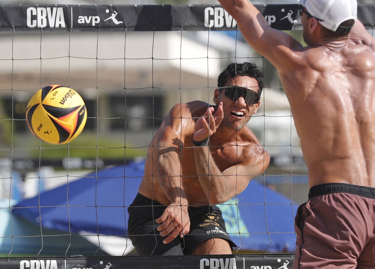 Silila Tucker kills a ball into the outside corner during the men's final of the Laguna Open beach volleyball tournament.  
