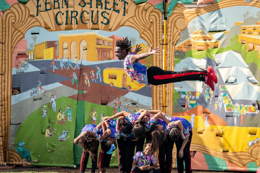 Guinean acrobat Idrissa Bangoura flies through the air at a Fern Street Circus performance.